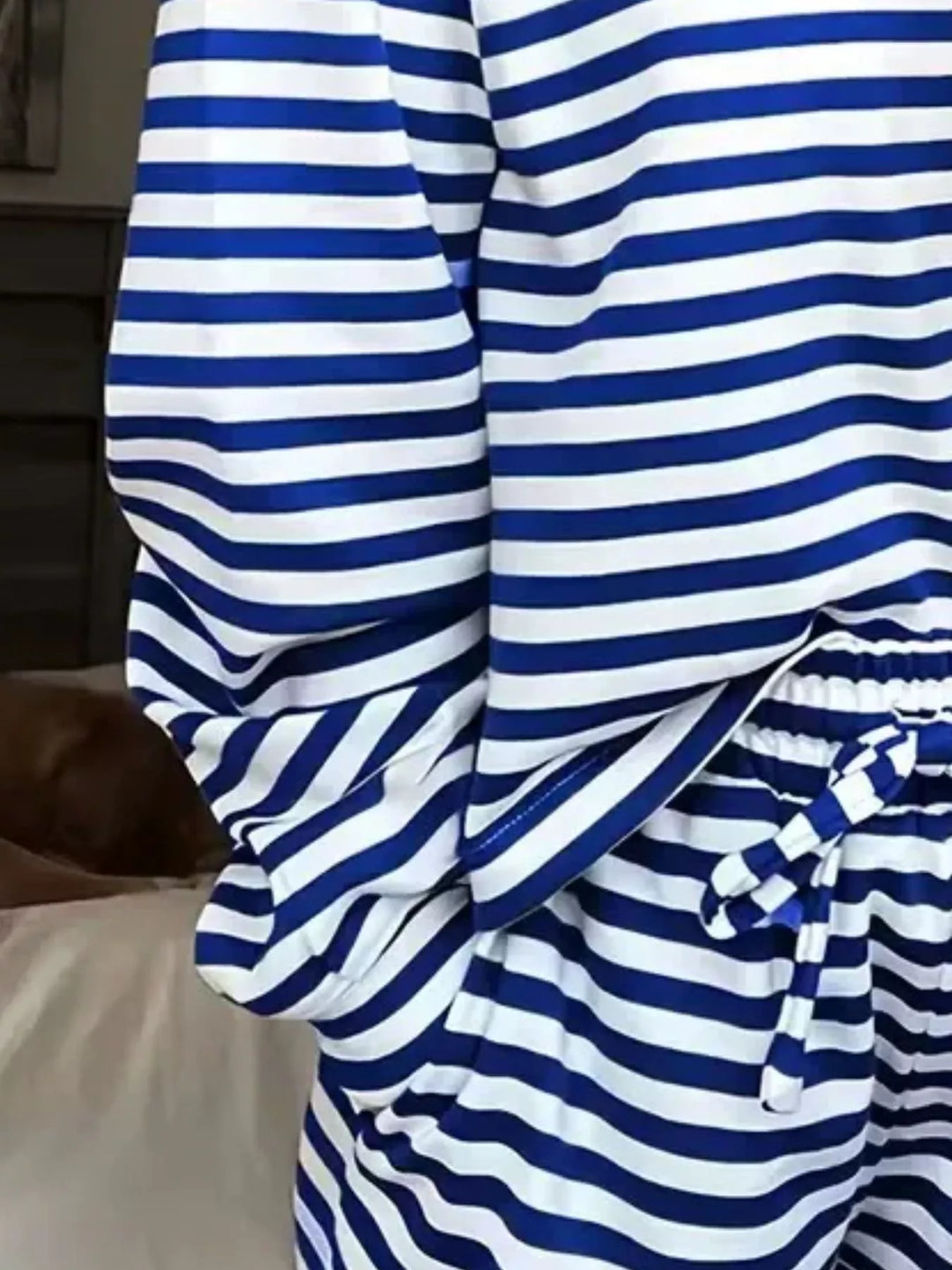 Close-up of the cobalt striped sleeve and tie waist of the lounge set
