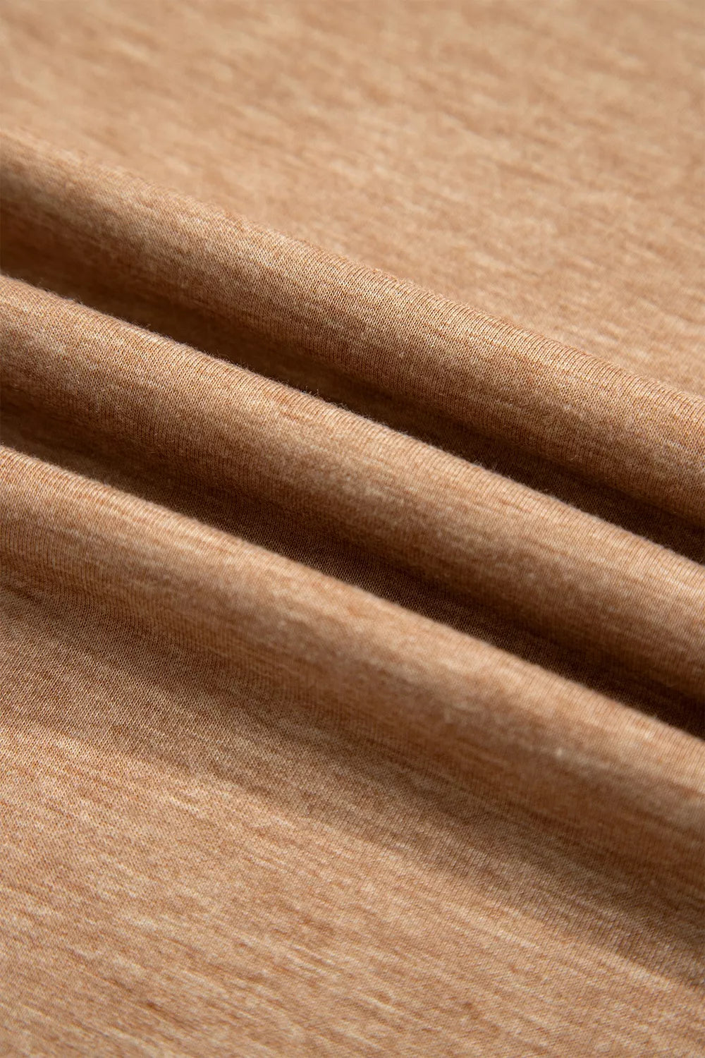 Soft folds of the camel lounge set fabric in a close-up