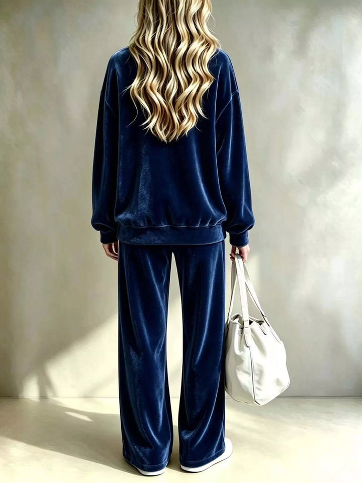 Navy pullover and wide leg pants set seen from behind with a white tote