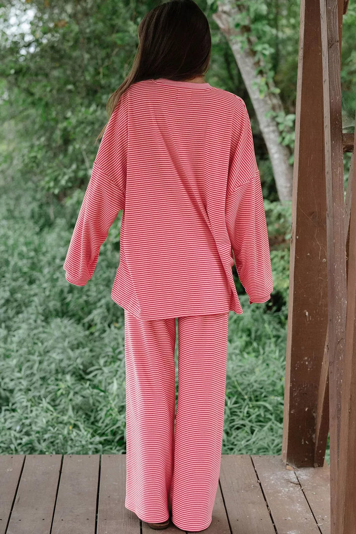 Dusty pink lounge set seen from behind with the oversized top draping loosely