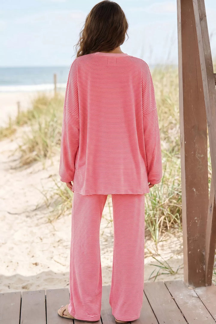 Back view of the dusty pink striped oversized top and wide pants on the beach