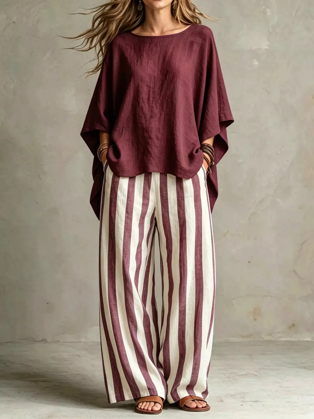 Burgundy batwing top and striped wide leg pants set, standing full length