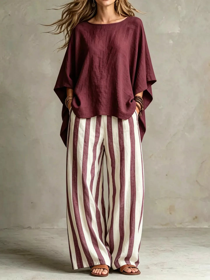 Burgundy batwing top and striped wide leg pants set, standing full length