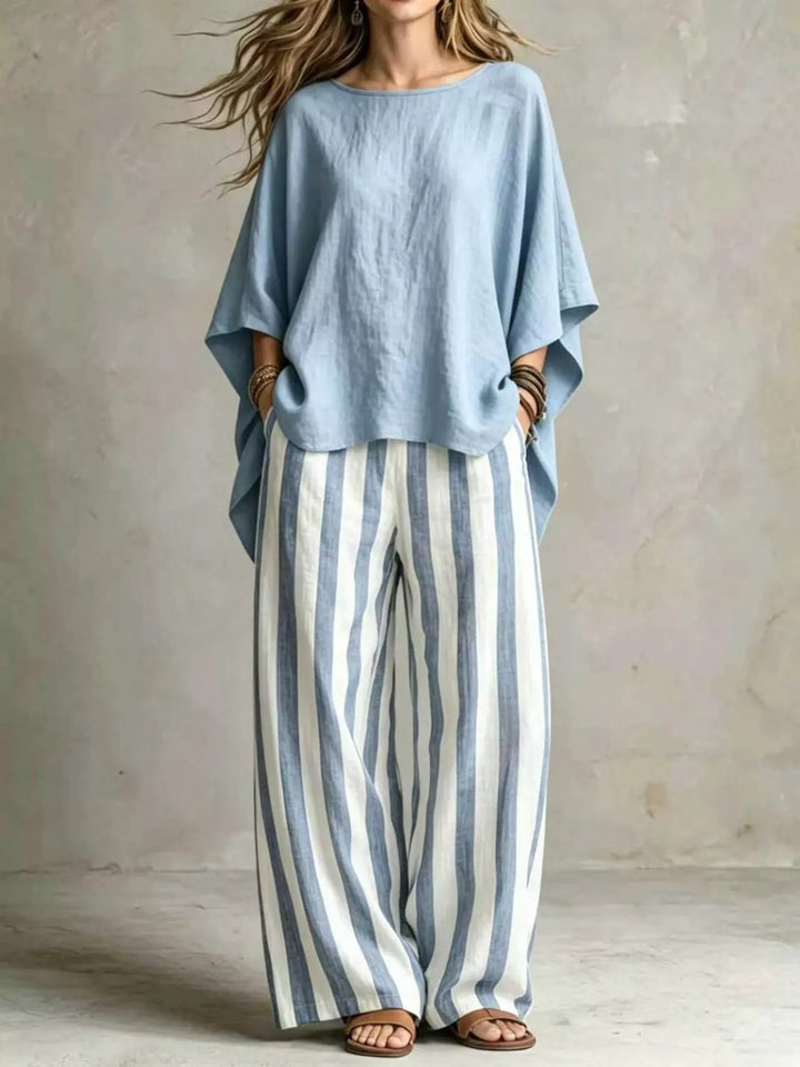 Light blue batwing top and striped wide leg pants set, full length view