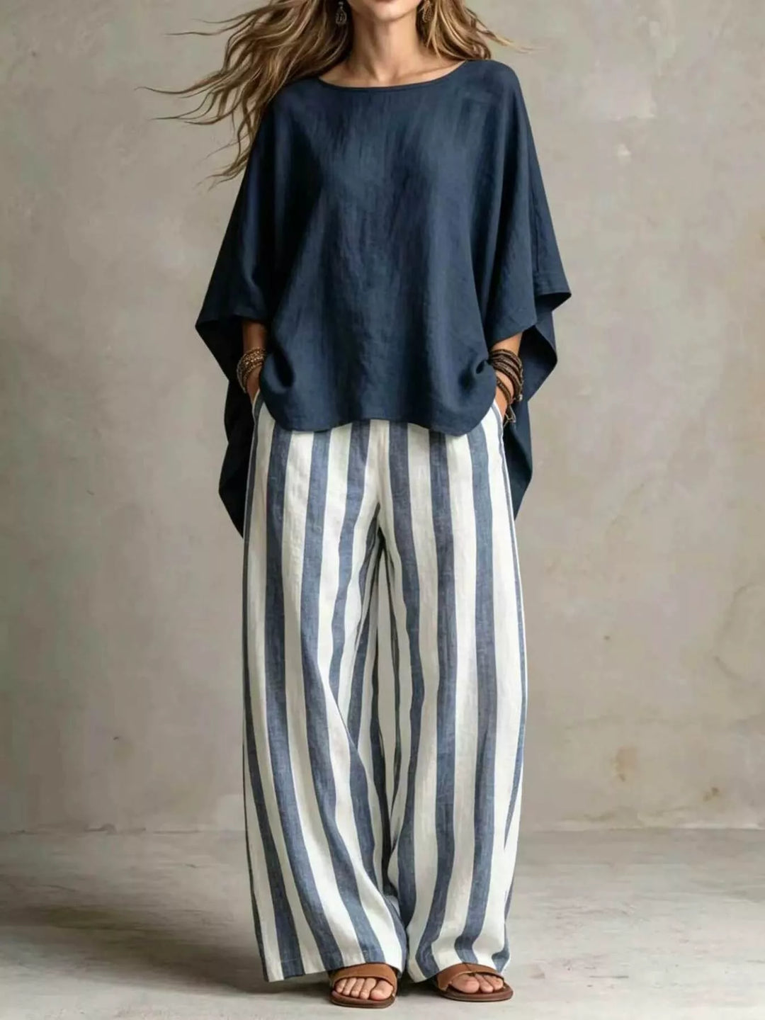 Navy batwing top and blue striped wide leg pants set, full length view