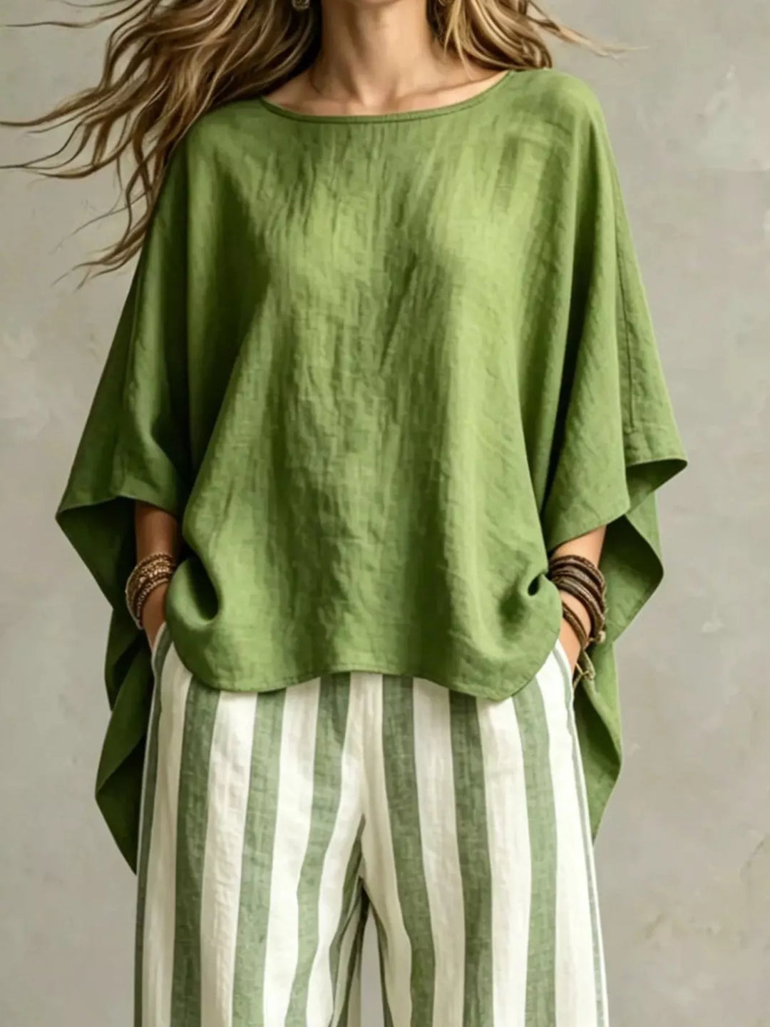 Olive batwing top with wide leg striped pants, closer front view