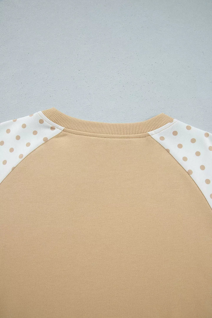 Back neckline of the tan cropped sweatshirt, close-up