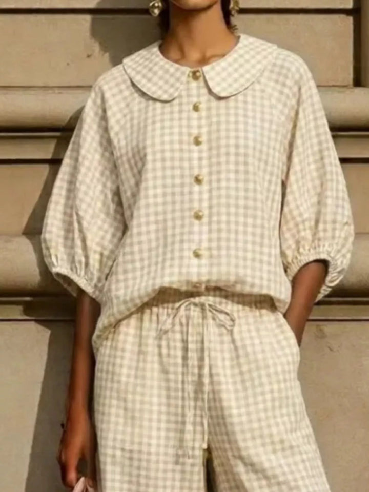 Close-up of beige gingham Peter Pan collar and buttons
