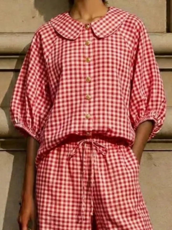 Close-up of red gingham top, puff sleeves and tie waist