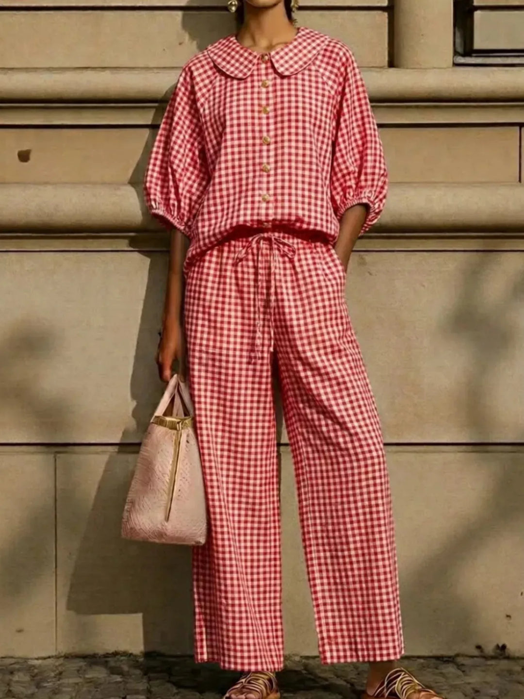 red gingham top and pants set with a bag in hand
