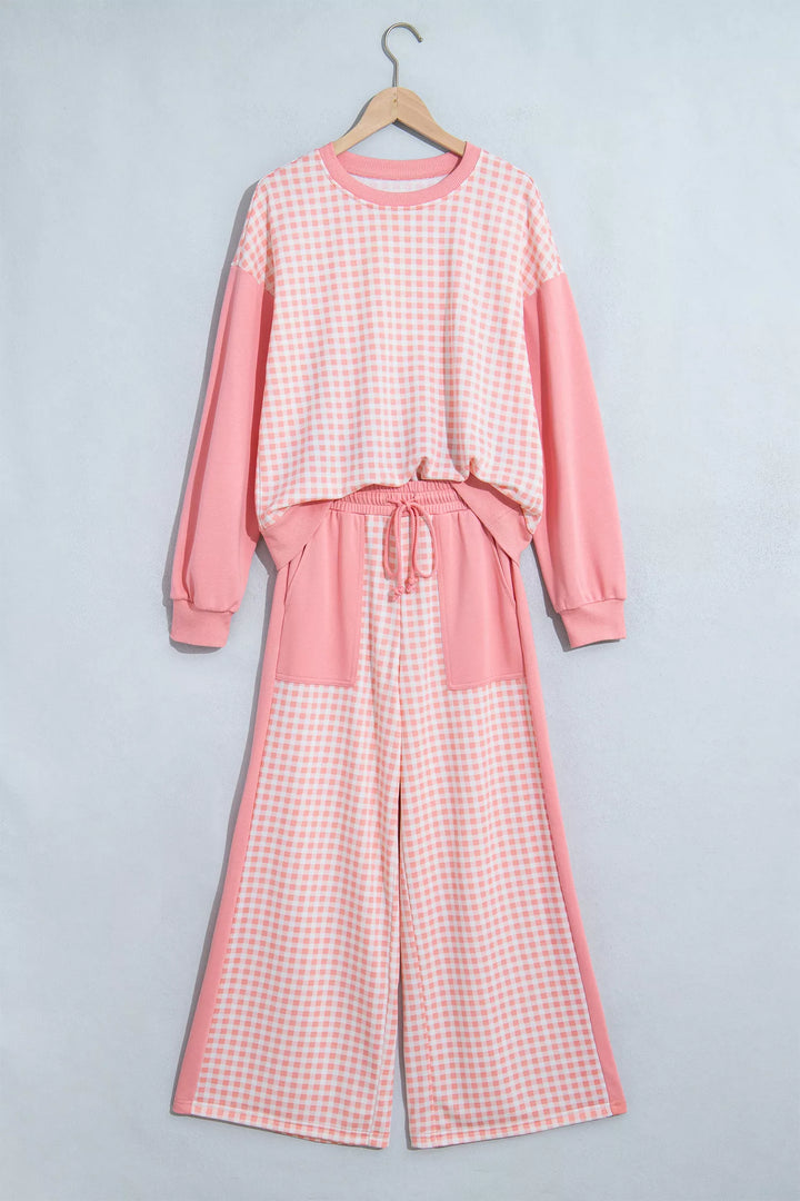 Coral pink gingham sweatshirt and wide leg pants hanging flat, drawstring waist