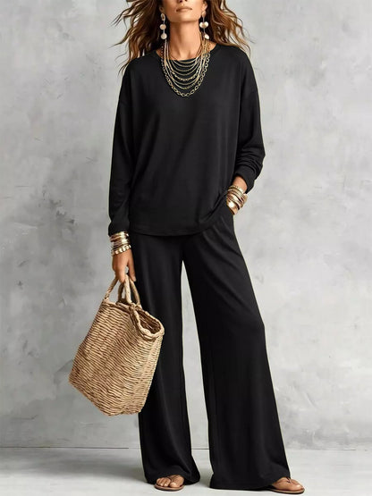 Black long sleeve tee and wide leg pants set with a woven tote