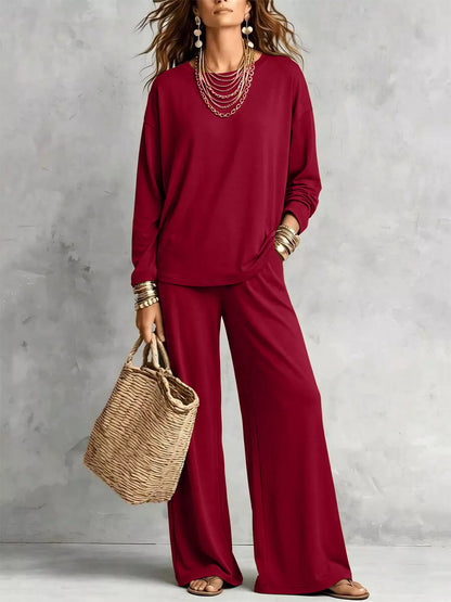 Burgundy tee and wide leg pants styled with a straw tote bag