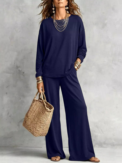 Navy long sleeve tee and wide leg pants set with a straw tote