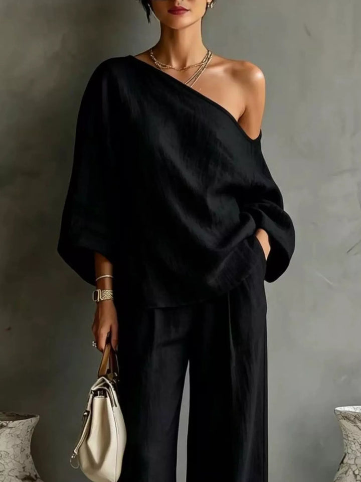 Close-up of the black one shoulder top with batwing sleeves