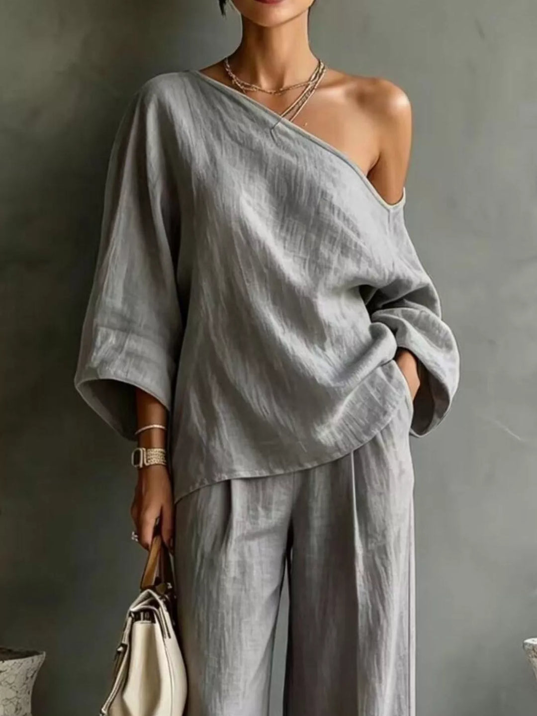 Close-up of the gray one shoulder top with batwing sleeves