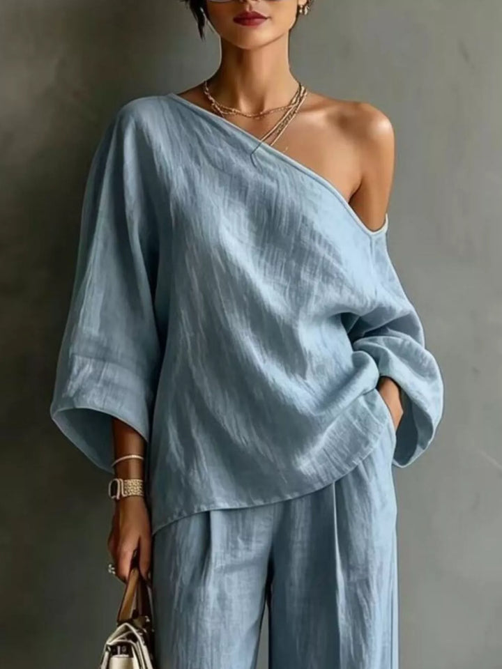 Close-up of the light blue one shoulder top with batwing sleeves
