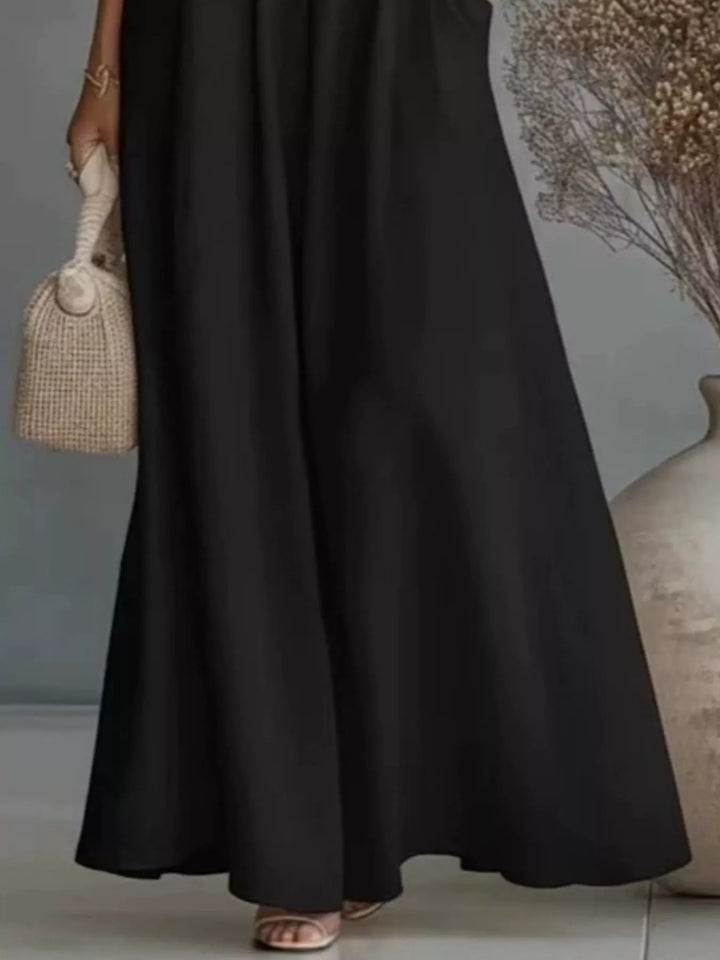 Lower half of the black wide leg maxi pants with wide flowing hem