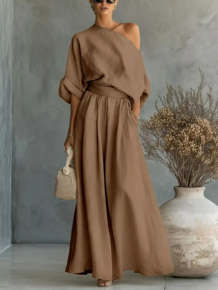 Mocha one shoulder top and wide leg maxi pants, full length with a woven bag