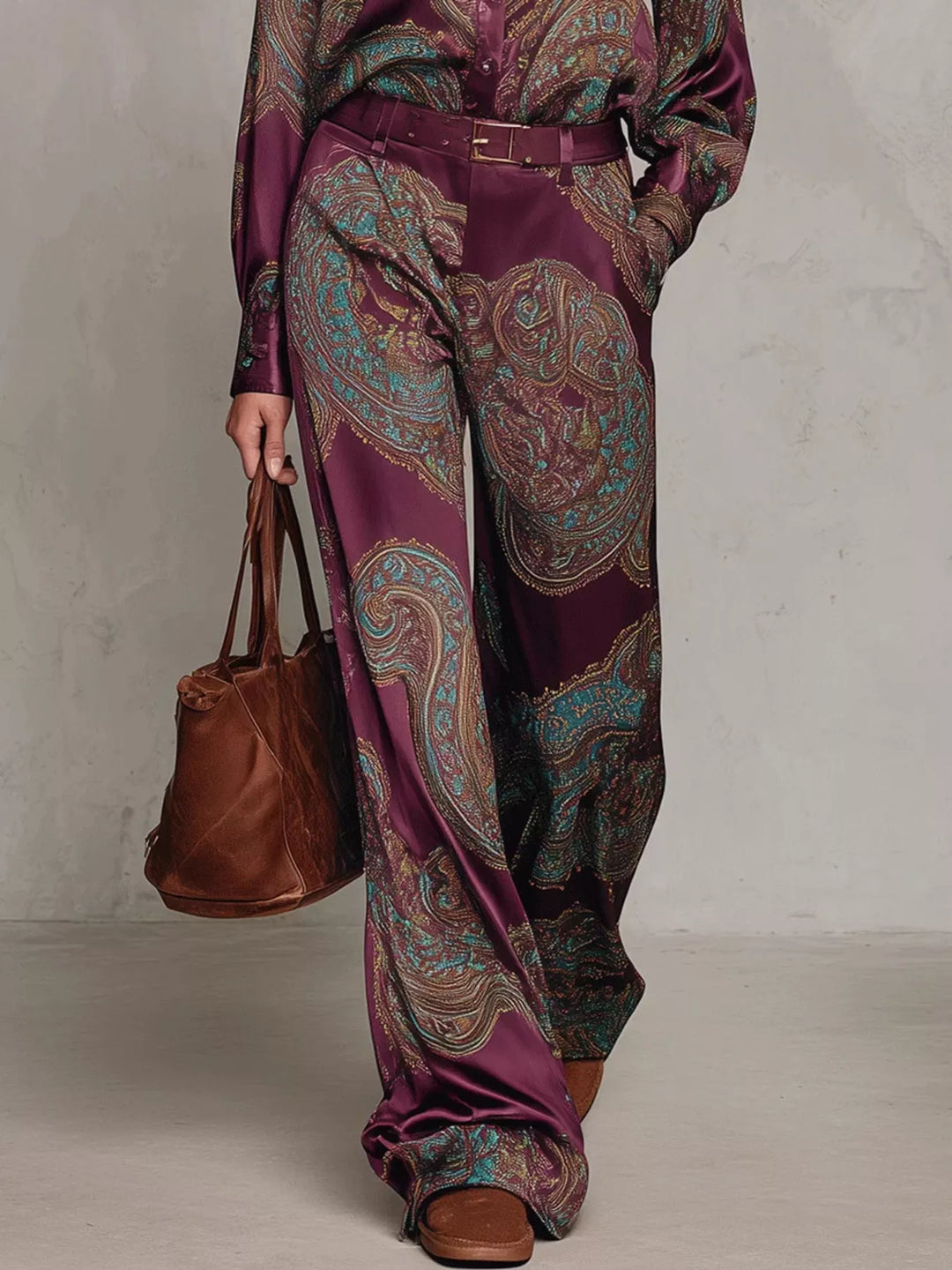Lower view of the burgundy paisley wide leg pants with brown tote and shoes