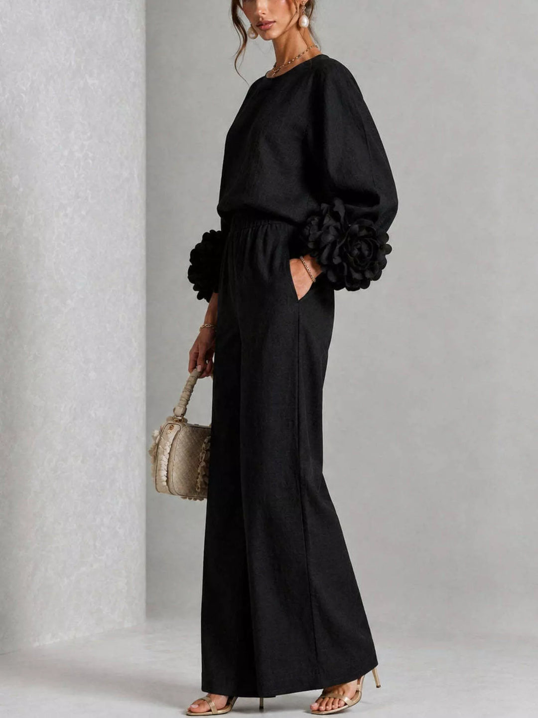Side view of the black puff sleeve set with hand in the pocket