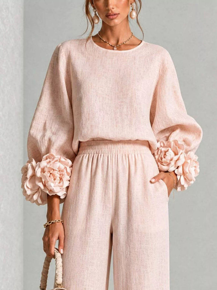 Close-up of the blush pink puff sleeve top with rose cuffs