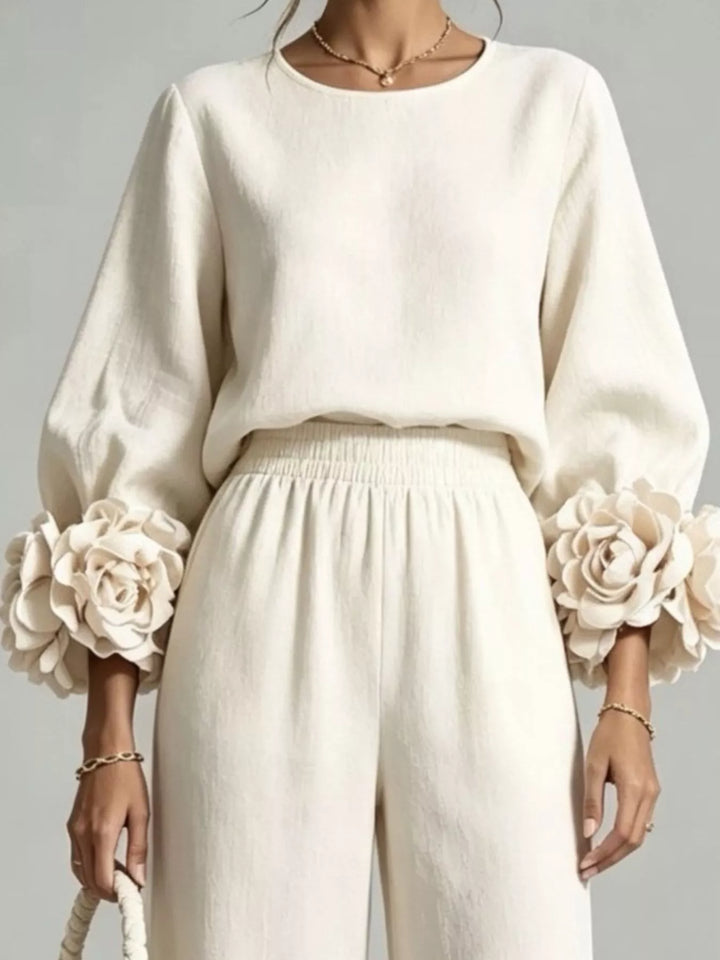 Close-up of the ivory puff sleeve top with oversized rose cuffs