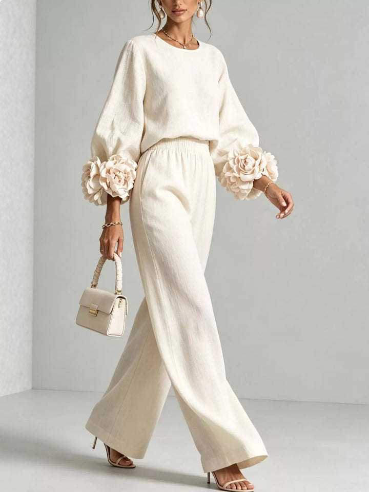 Ivory wide leg pants set, model walking with a small white handbag