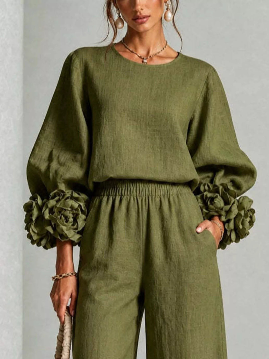 Close-up of the moss puff sleeve top with ruffled cuffs and elastic waist