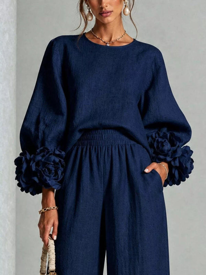 Close-up of the navy puff sleeve top with ruffled cuffs