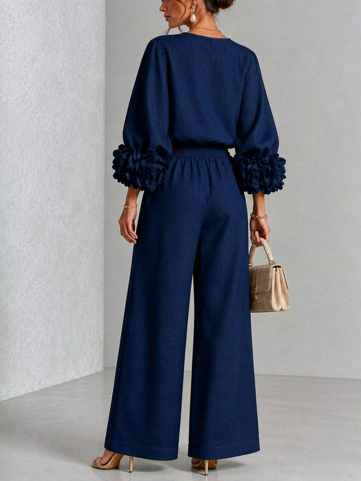 Navy wide leg pants set, standing pose with a handbag in hand