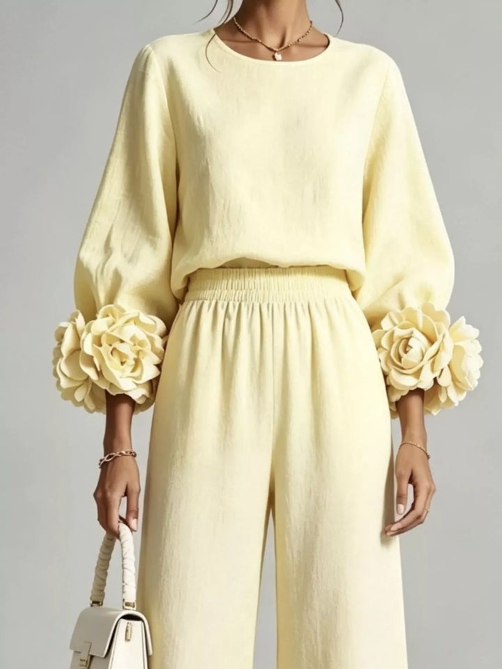 Close-up of the pastel yellow top with floral rose cuffs