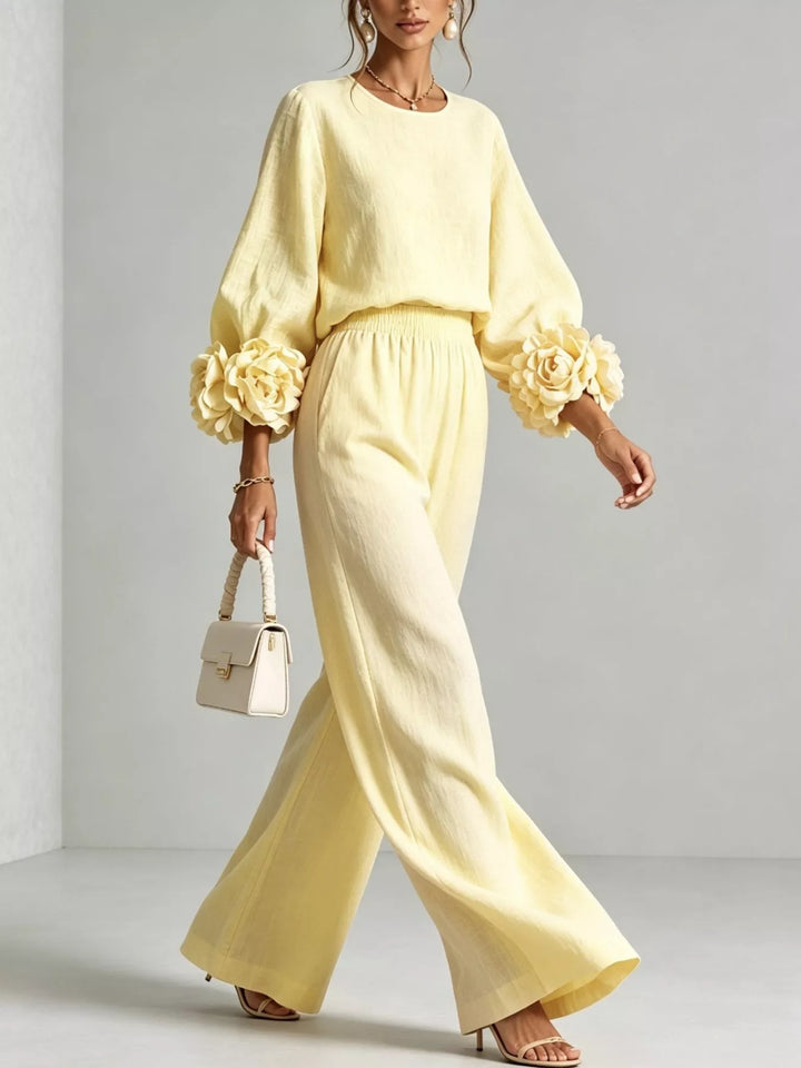Pastel yellow set in motion, walking in wide leg pants with a white handbag
