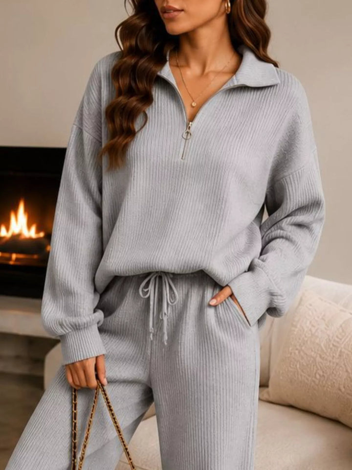 Close-up of the light gray half zip collar and drawstring pants