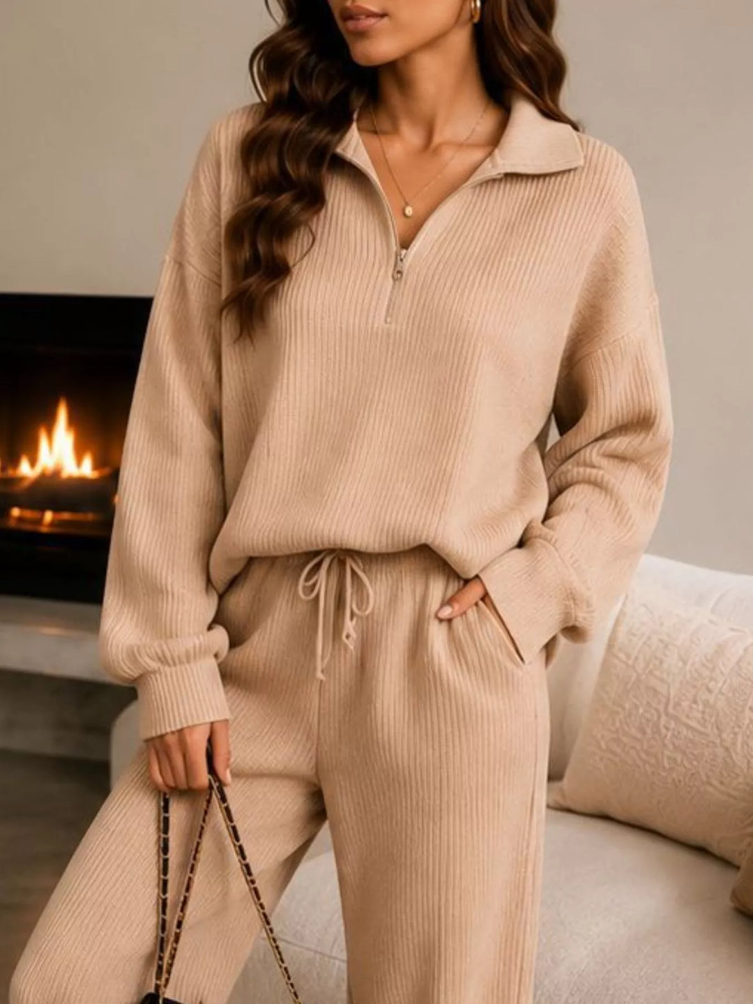 Close-up of the tan half zip collar and drawstring waist with a bag