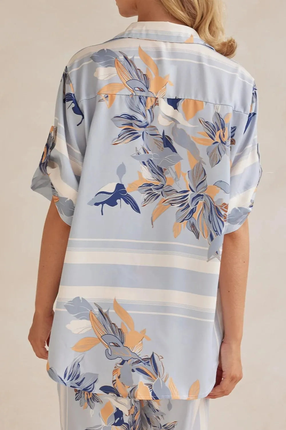 Back of the light blue floral button up shirt with leaf print and stripes