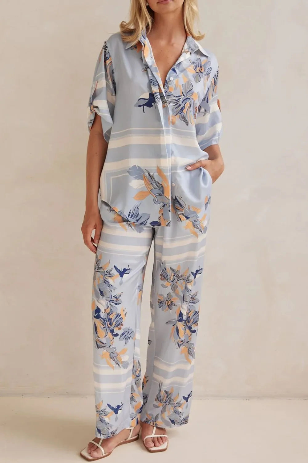 Women's matching set in light blue floral, satin look button up shirt and pants, front view