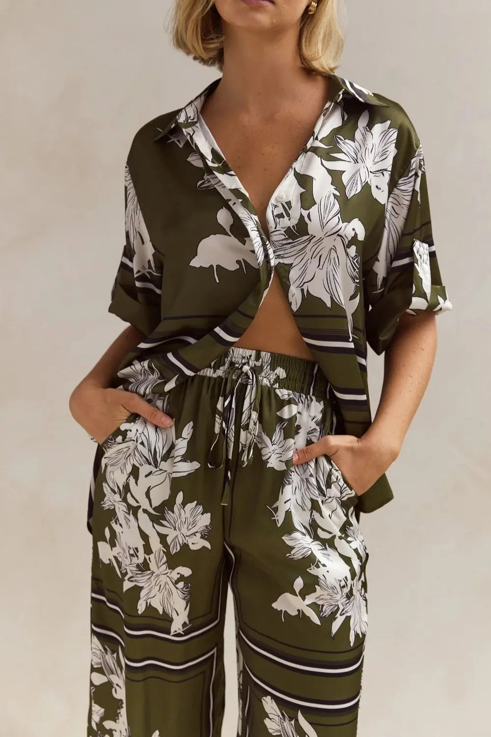 Olive floral shirt and drawstring pants in a close three quarter view