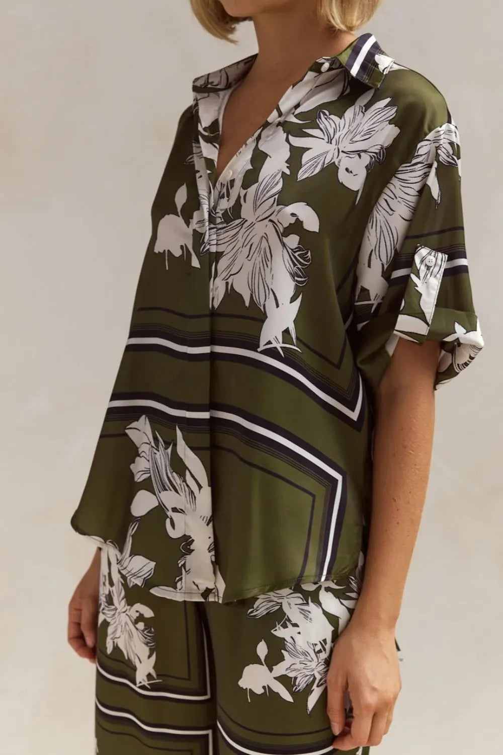 Side view of the olive floral shirt with white leaf print and stripe panel