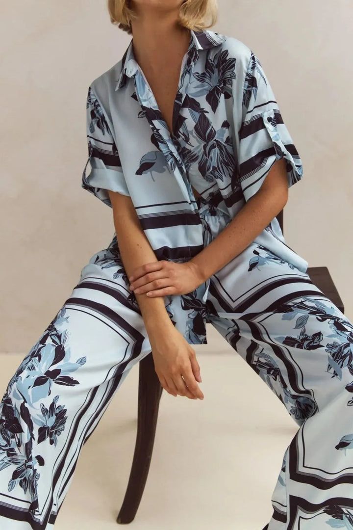 Sky blue print set worn seated on a stool, showing the relaxed pants