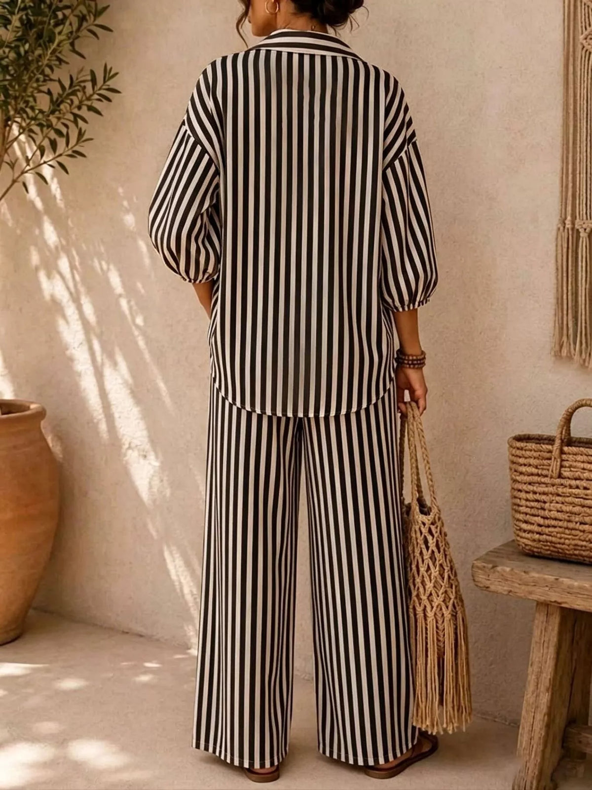 Back view of the black stripe shirt and wide leg pants matching set