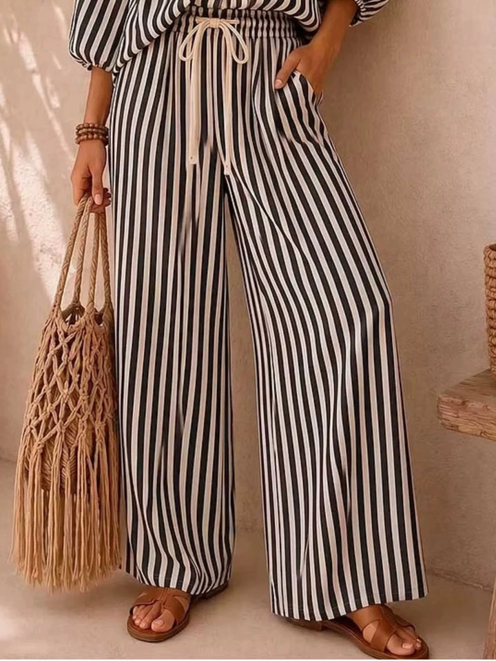 Black striped wide leg pants with drawstring waist, lower body with woven bag
