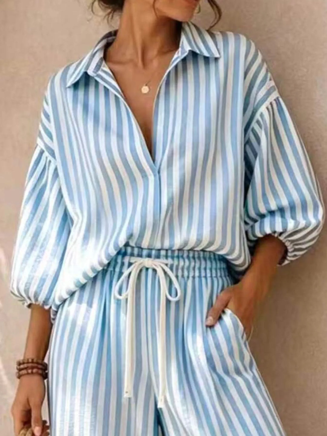 Close-up of the light blue striped top and drawstring waistband