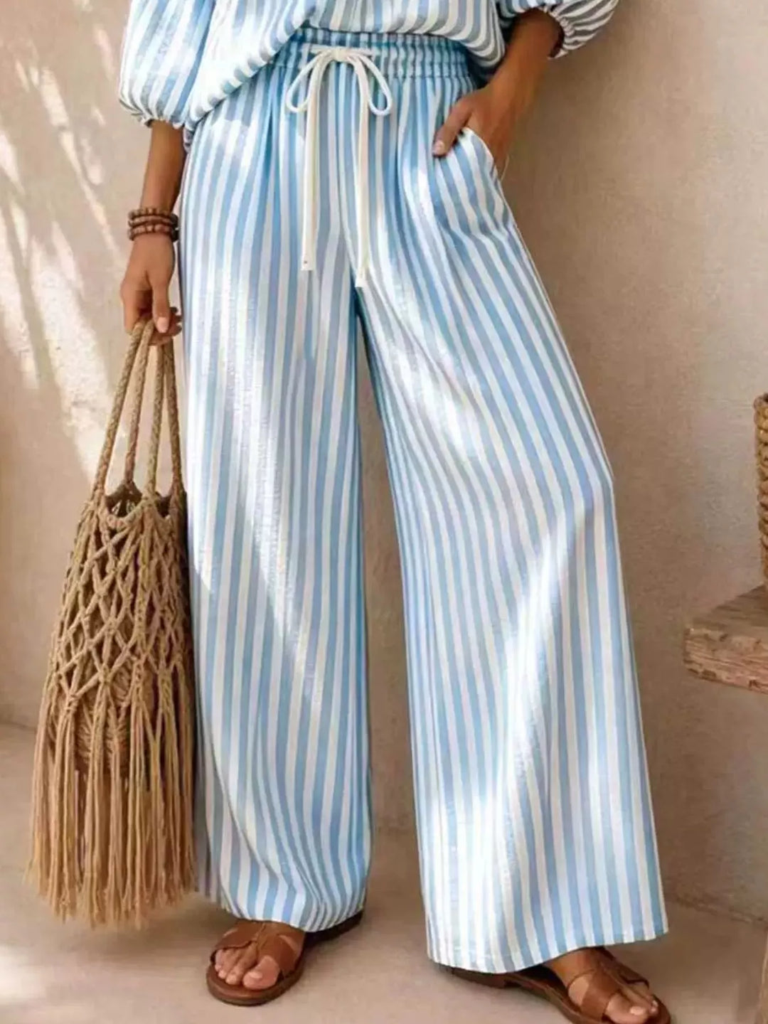 Light blue striped wide leg pants with drawstring, lower body view