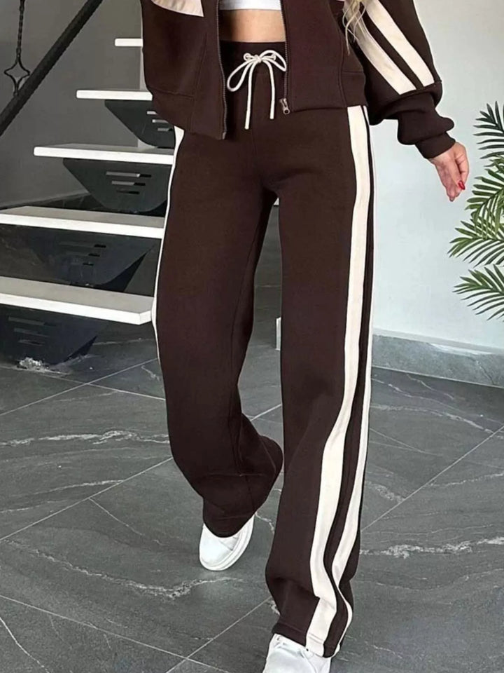Chocolate brown tracksuit pants with side stripe and white sneakers