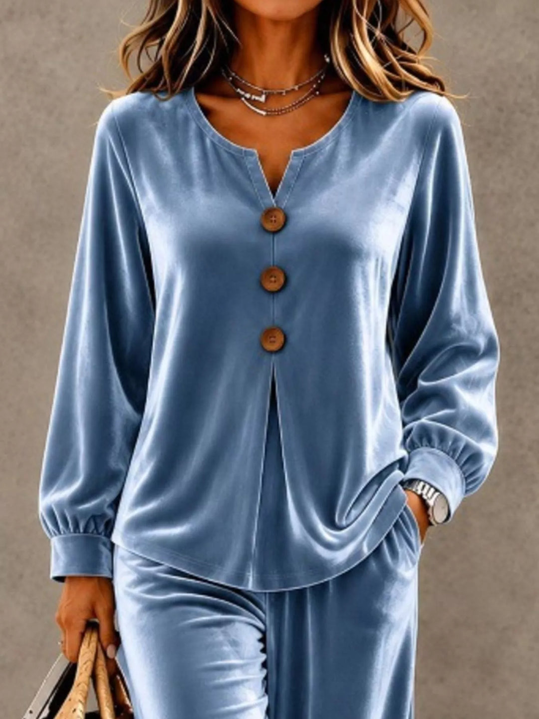 Close-up of the dusty blue top with button front and gathered cuffs
