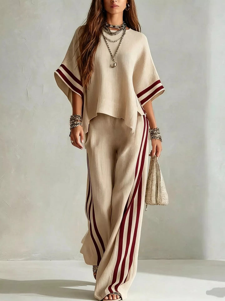 Women's matching set in beige, wide sleeve top with striped pants and a woven bag