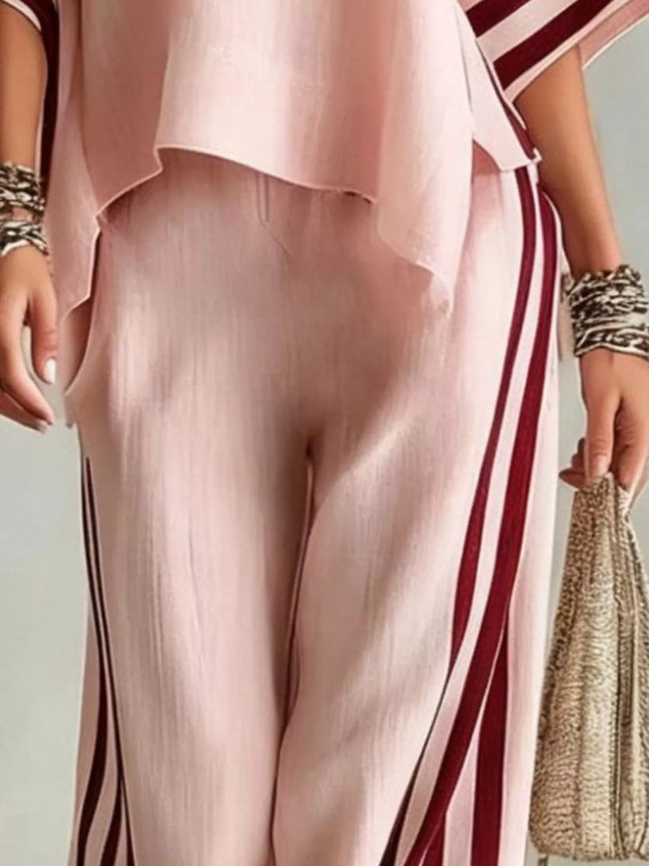 Detail of the blush pink wide leg pants with burgundy side stripes