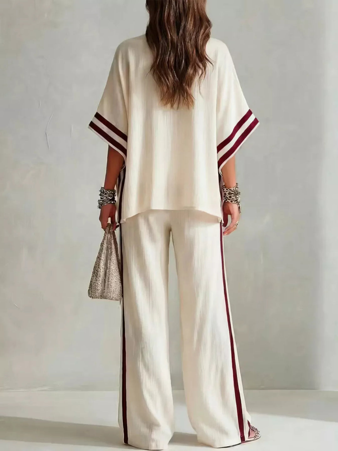 Back view of the cream wide sleeve top and striped pants set