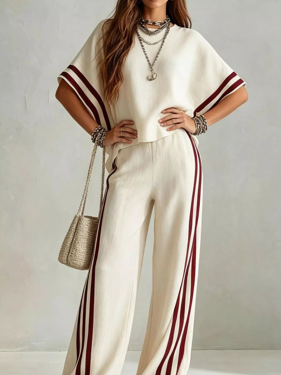 Cream wide sleeve top and pants, model with hands on hips